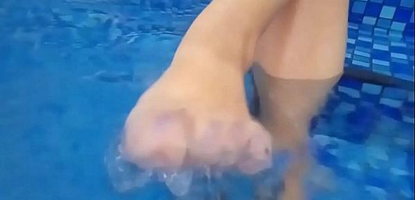  Foot fetish in pool. Mature plays with her legs in the water and teases you with wet feet.